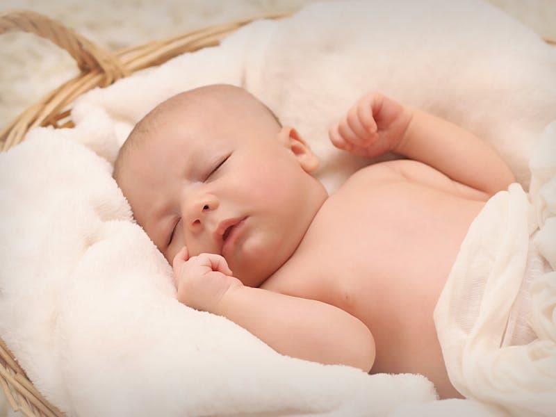 Baby sleeping peacefully in a cot